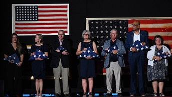 group holding flags - Fox News