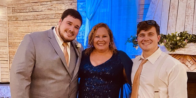 Ryan Christian Knauss, right, poses for a photo with his mother Paula and brother Tyler.