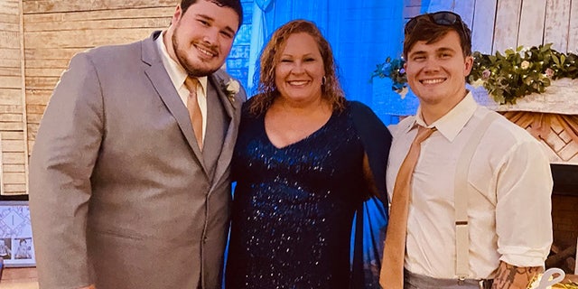 Ryan Christian Knauss, right, poses for a photo with his mother Paula and brother Tyler.