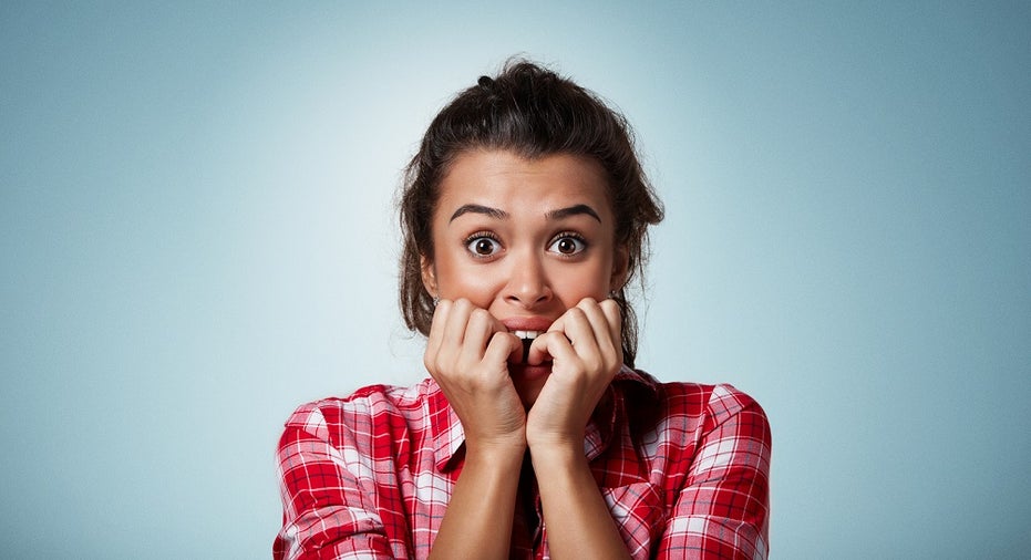 Close-up Portrait Of A Young Woman Scared ,afraid And Anxious Biting Her Finger Nails, Looking At Ca