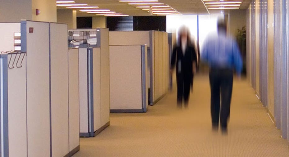 Workers Walk by Office Cubicles