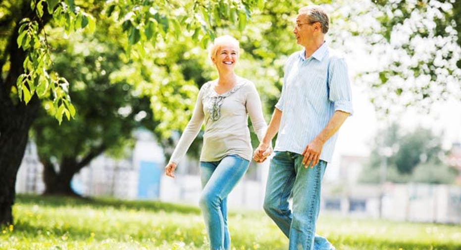 Happy mature couple walking in the field.