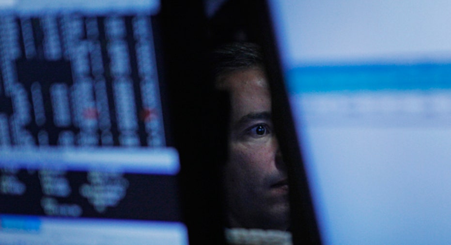 Stock Trader Surrounded by Monitors, Reuters