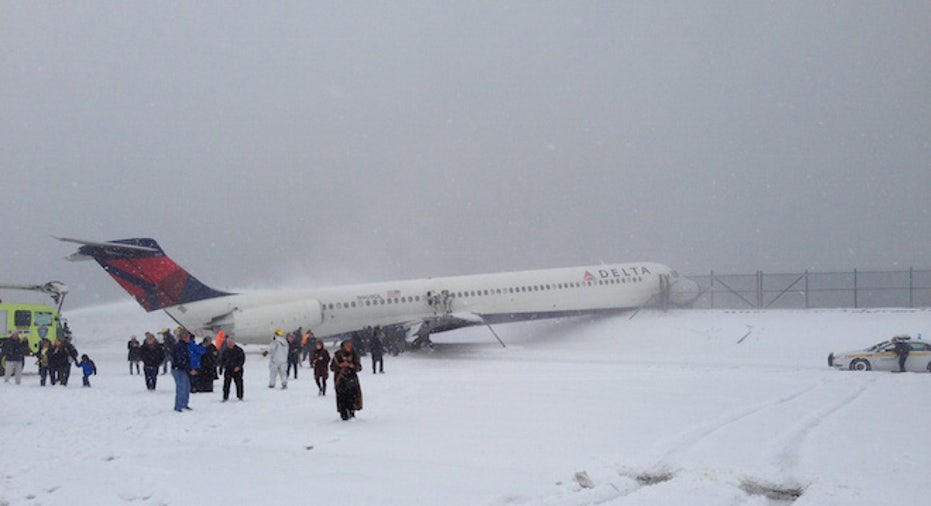 Plane skids off runway at LaGuardia, crashes through fence