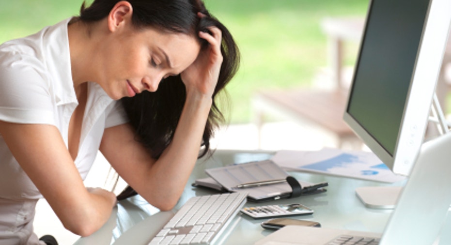 Woman looking stressed at her desk