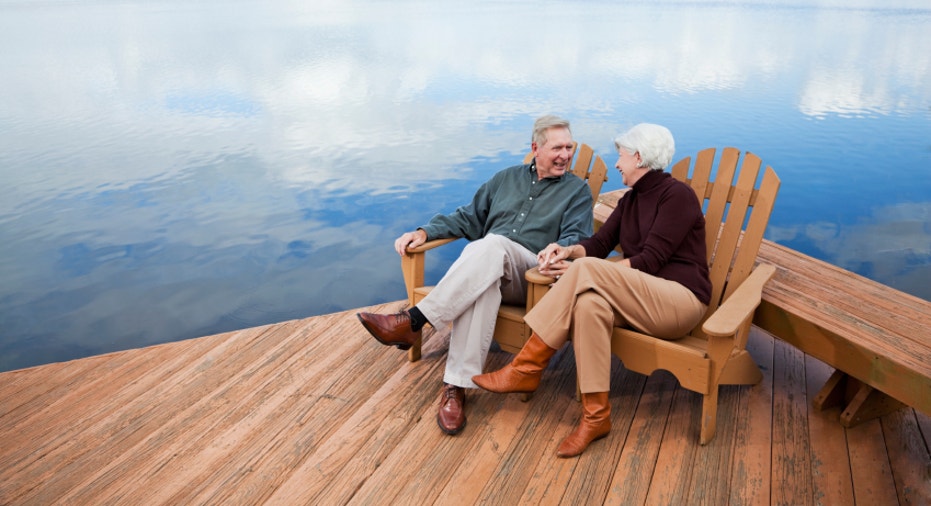 Senior couple sitting by water