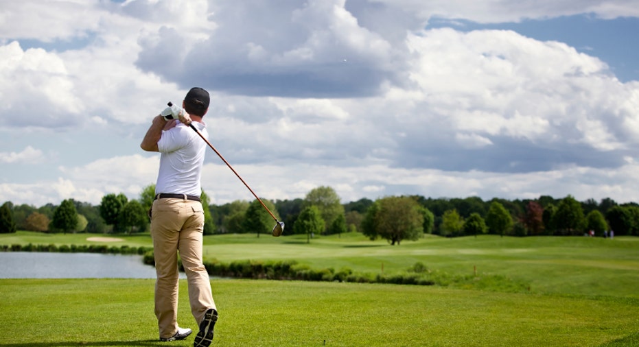 Golf player teeing off