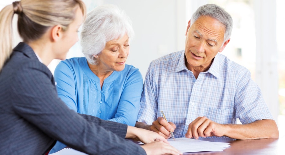 Financial Advisor Explaining Investment Plans To Senior Couple.