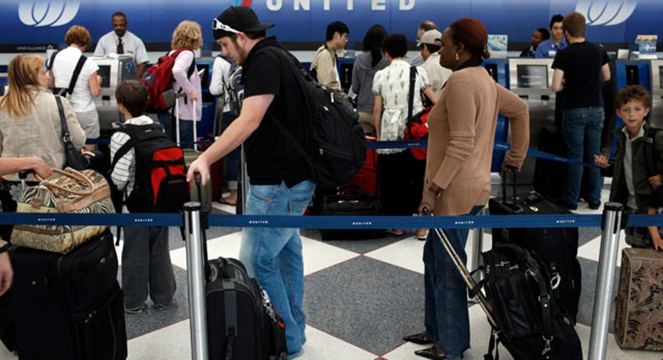 people waiting in line to check in at airport