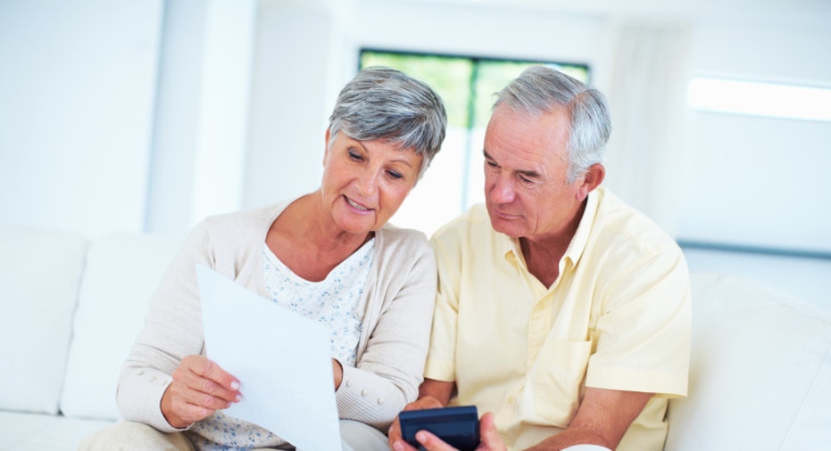 Mature couple calculating bills