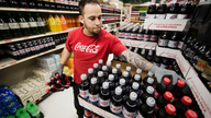Coca-Cola's 2Q profit hurt by charge, but still tops Street