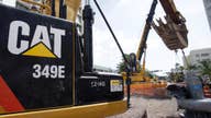 Caterpillar reports 4Q loss