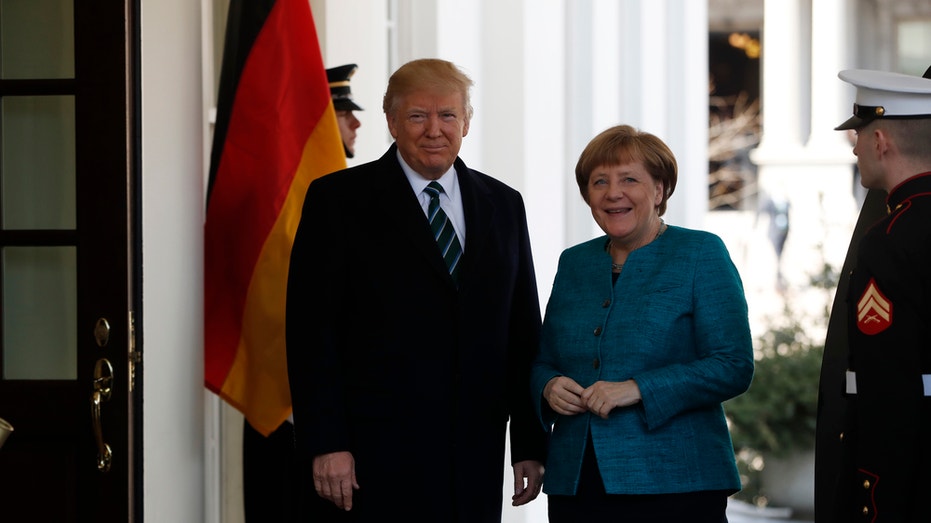 President Donald Trump greets German Chancellor Angela Merkel outside the West Wing of the White House in Washington