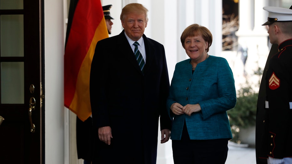 President Donald Trump greets German Chancellor Angela Merkel outside the West Wing of the White House in Washington
