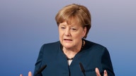 Neck rubs, tapped phones: Merkel has history with US leaders