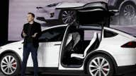 Tesla lowers price of Model X, saying margins improved