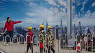 IMF raises China growth forecast but warns on debt
