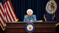 The Latest: As Fed eyes rate hike, markets edge lower