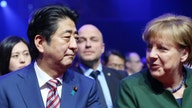 Germany's Merkel and Japan's Abe Urge Free Trade with Jabs at U.S.