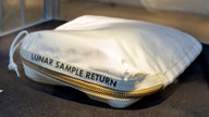 Apollo 11 bag laced with moon dust sells for $1.8 million