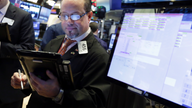 US stocks swing back to gains, Dow up 330 on turbulent day