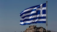 IMF approves conditional $1.8 billion loan to Greece