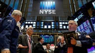 Dow edges up to record high, financials dips