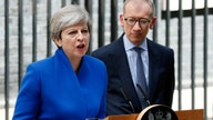 Tottering Theresa May names new UK Cabinet as critics circle