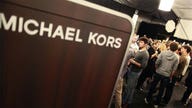 Michael Kors lifts revenue forecast, shares soar