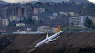 Plane dangles off cliff after skidding off runway in Turkey