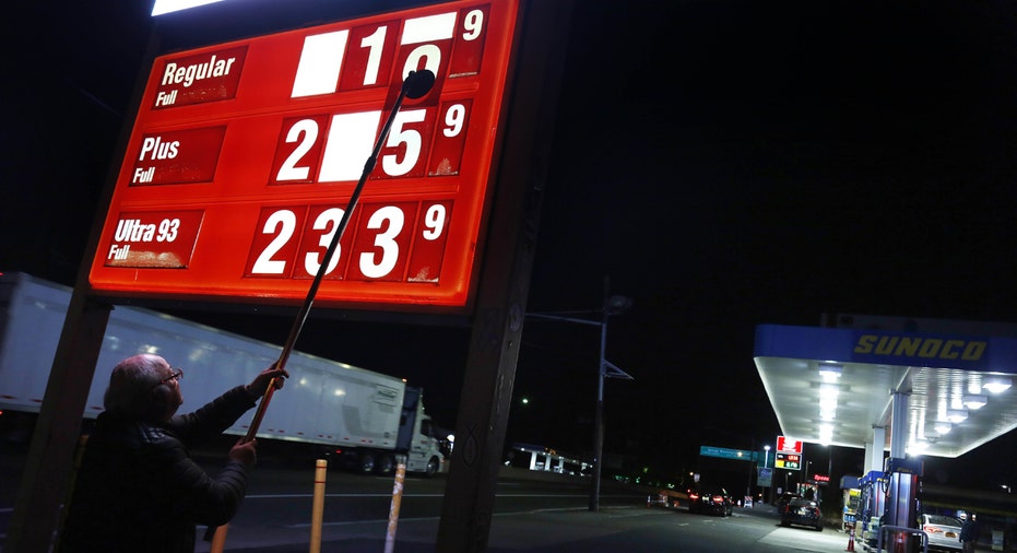 Gas station owner changing price sign FBN