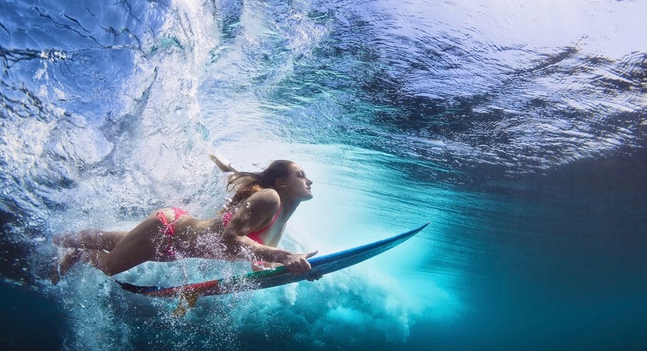 Underwater Photo Of Girl With Board Dive Under Ocean Wave