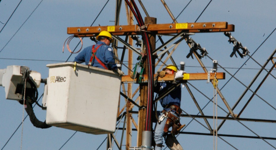 Man Works on Electric Pole