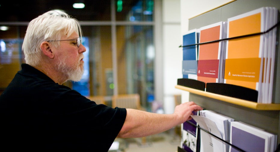 Elderly Man Looks Through Retirement Pamphlets