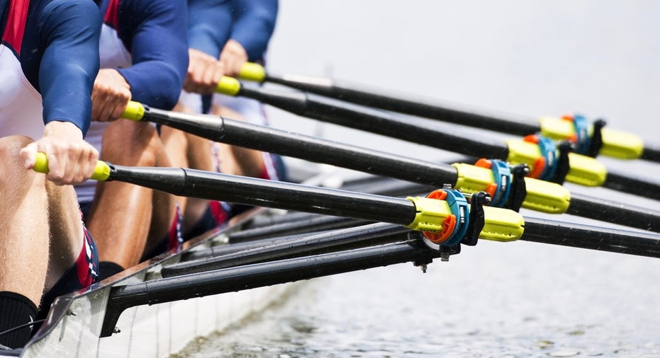 Close up of a men's quadruple skulls rowing team, seconds after the start of their race
