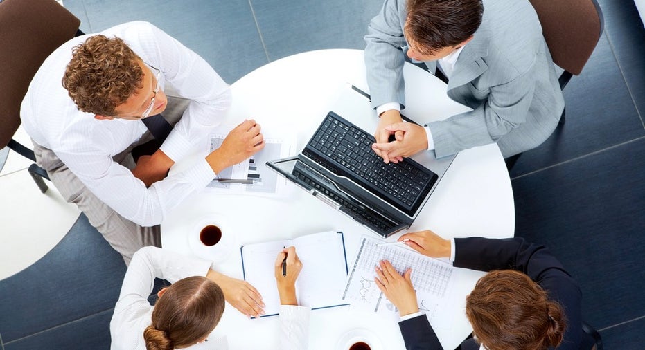 Above view of several business people planning work at round table