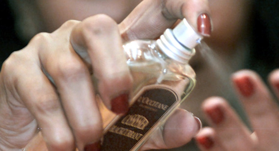 woman spraying perfume