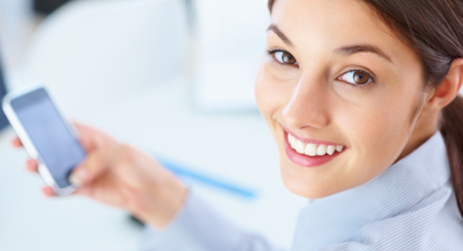 Cute female executive using mobile phone