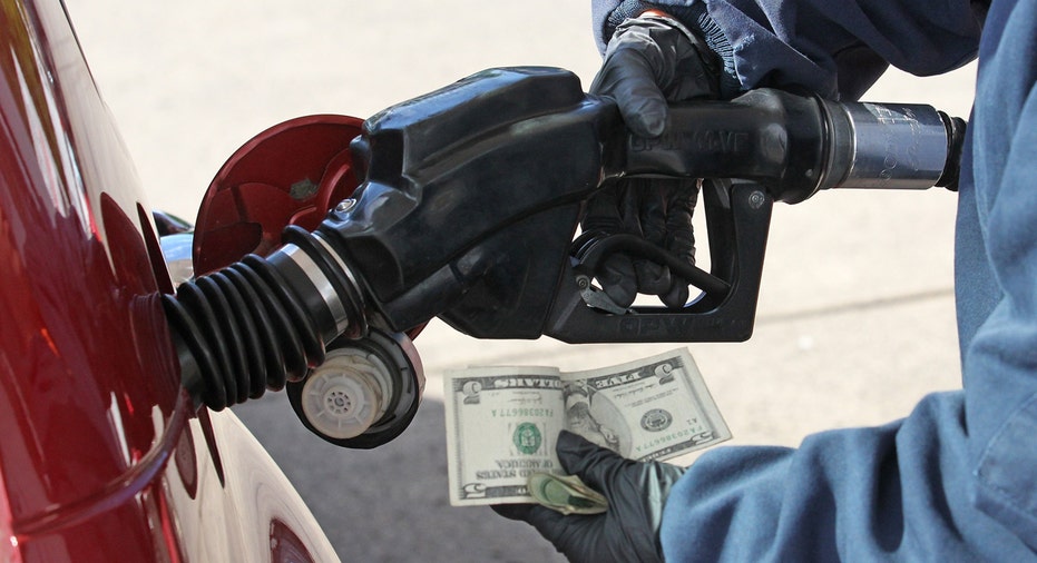 Gas station, driver pumping gas holding money FBN