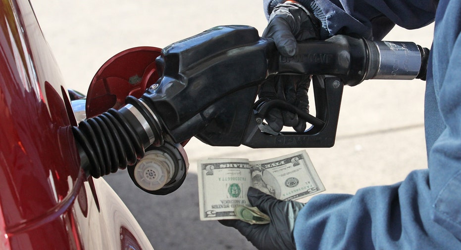 Gas station, driver pumping gas holding money FBN