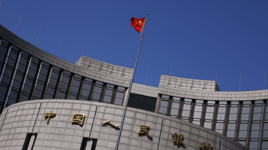 Chinese flag flies outside of stone building during daytime