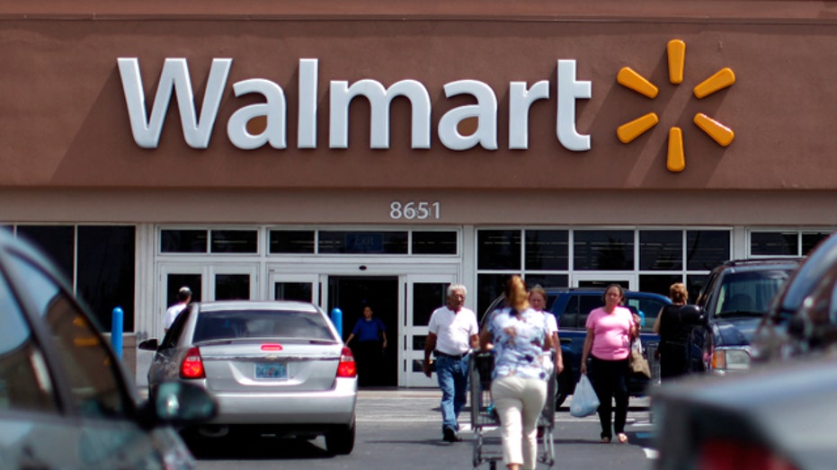 Customers walking in a Walmart parking lot.