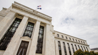 Fed keeps key rate steady but notes rising inflation