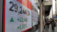 Asian shares mixed as Fed hike gives investors few surprises