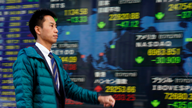 Global shares mixed in listless trading on Wall Street slip