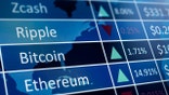 Cryptocurrency market statistics. Photograph of computer screen.