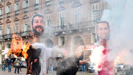 Students protest Italy's spending plans, burning effigies