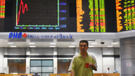 World stocks slide after IMF trims economic outlook