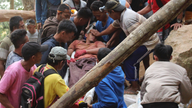 Workers dig by hand to free dozens in Indonesia mine rubble