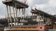 Workers carefully remove remains of collapsed Genoa bridge